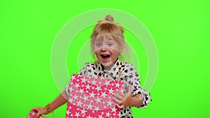 Cheerful stylish child girl opening gift box, great happiness amazement, satisfied with best present