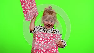 Cheerful stylish child girl opening gift box, great happiness amazement, satisfied with best present
