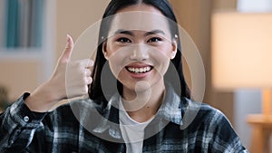 Cheerful successful asian korean positive woman girl female dental service client smiling toothy smile showing thumbs up