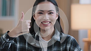 Cheerful successful asian korean positive woman girl female dental service client smiling toothy smile showing thumbs up