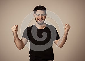 Cheerful surprised and happy man celebrating victory and wining lottery