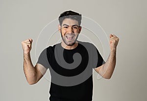 Cheerful surprised and happy man celebrating victory and wining lottery