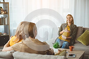 Cheerful surrogate expectant mother meeting married couple