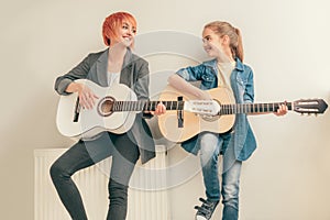 Cheerful teacher and student during music lesson