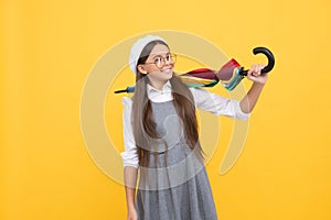 cheerful teen child hold colorful parasol. kid in beret with rainbow umbrella. autumn season