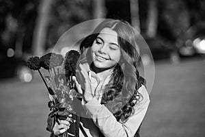 cheerful teen girl with autumn flowers outside. teen girl with autumn flowers. teen girl with autumn flowers outdoor