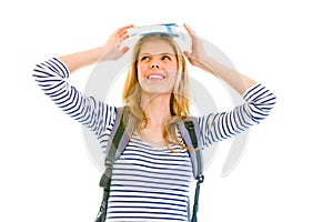 Cheerful teen girl balancing book on top of head