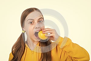 cheerful teen girl with citrus fruit lemon full of vitamins isolated on white, detoxication