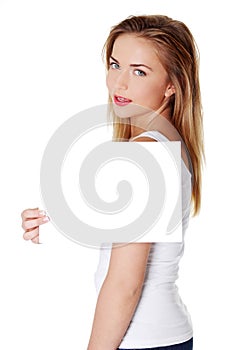 Cheerful teen girl holding blank white paper