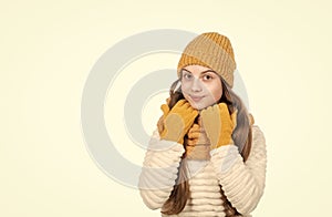 cheerful teen girl in knitted hat scarf and gloves isolated on white copy space, cold weather.