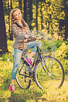 Cheerful teenage on a bicycle outdoors