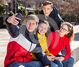 Cheerful teenage friends making selfie