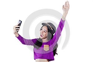 Cheerful teenage girl holds cellphone
