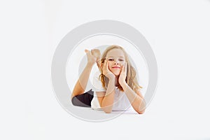 Cheerful teenage girl in white t-shirt and black breeches on white background