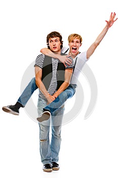 Cheerful teenager piggy backing his friend