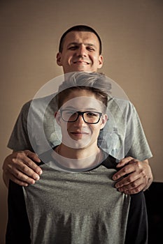 Cheerful teenager son with father portrait