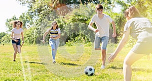 Cheerful teenagers are jogning with ball