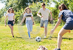 Cheerful teenagers are jogning with ball