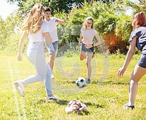 Cheerful teenagers are jogning with ball