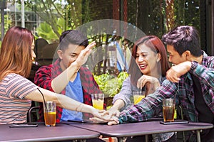 Cheerful teenagers joining hands together