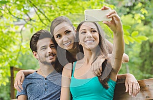 Cheerful teens at the park taking selfies