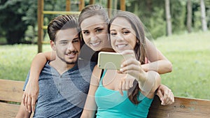 Cheerful teens at the park taking selfies