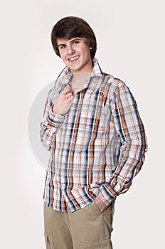 Cheerful toothy young man in checked shirt and smart casual wear