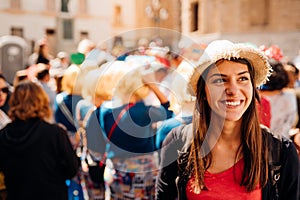 Cheerful tourist visiting to the public celebration,attending carnival.Carnival season.Crowd in costumes traditionally parading