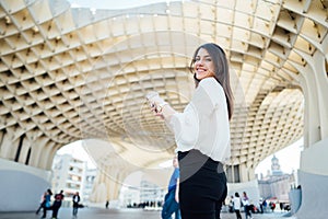 Cheerful tourist woman on vacation in Andalusia, visiting Setas de Sevilla- Metropol Parasol at the La EncarnaciÃ³n square in