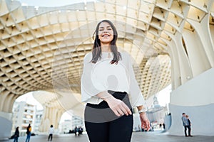 Cheerful tourist woman on vacation in Andalusia, visiting Setas de Sevilla- Metropol Parasol at the La EncarnaciÃ³n square in