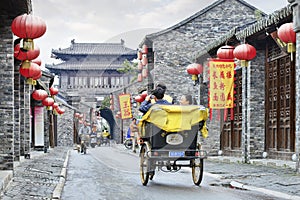 Cheerful tourists in a rickshaw, Beijing, China