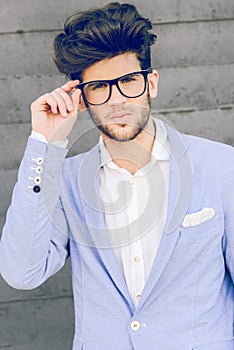 Cheerful trendy guy with black eyeglasses on