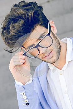 Cheerful trendy guy with black eyeglasses on