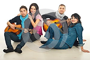 Cheerful two couples with guitars