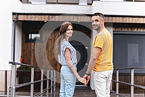 Cheerful twosome looking at camera with wide smile