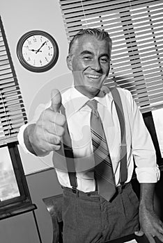 Cheerful vintage businessman thumbs up