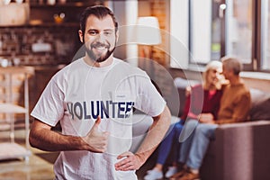 Cheerful volunteer showing his thumb up