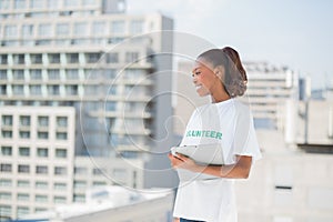 Cheerful volunteer woman holding clipboard