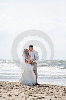 Cheerful wedding couple on the beach