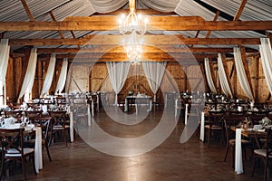 Cheerful wedding reception taking place in a rustic barn setting.