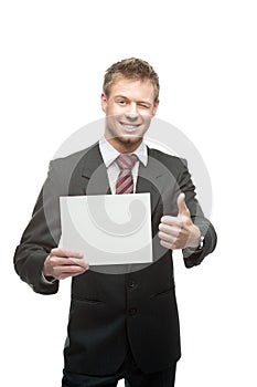 Cheerful winking businessman holding sign