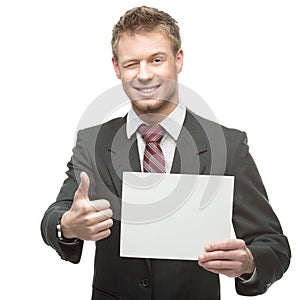 Cheerful winking businessman holding sign