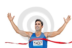 Cheerful winner athlete crossing finish line