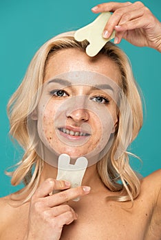 cheerful woman with blemishes using face photo