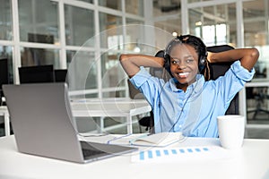 Cheerful woman call center operator having break during her work