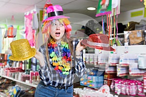 Cheerful woman choosing funny headdresses