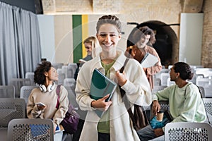 cheerful woman with copybooks looking at