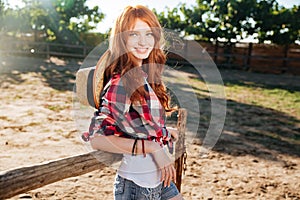 Cheerful woman cowgirl standing in village