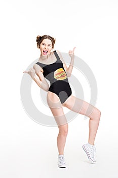 Cheerful woman dancing and showing thumbs up with both hands