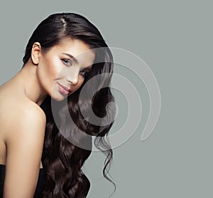 Cheerful woman with dark brown curly hair, haircare and beauty salon background